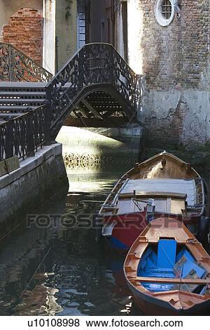 Building reflected in quite canal - boats moored at side. Bridge with steps over canal. View Large Photo Image Stock Photo - Building reflected in quite canal - boats moored at side. Bridge with steps over canal.. Fotosearch