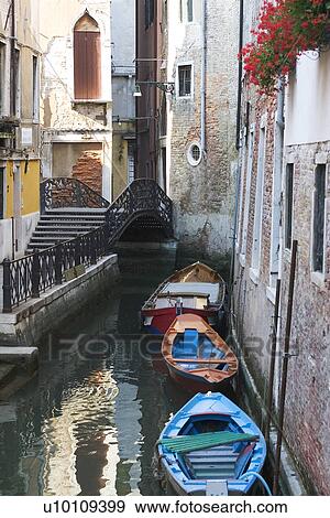 Building reflected in quite canal - boats moored at side. Bridge with steps over canal. View Large Photo Image Stock Photo - Building reflected in quite canal - boats moored at side. Bridge with steps over canal.. Fotosearch
