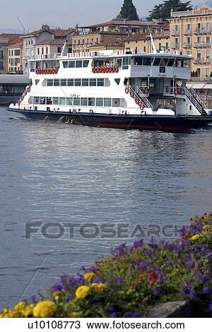 Stock Image - Car ferry on Lago di Como Italy departing Bellagio hills and town in background. Fotosearch