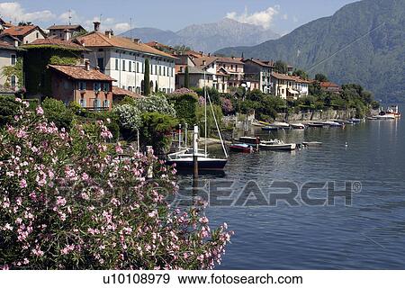 Stock Photo - Lago di Como lakeside homes and docks with pleasure boats near Urio Ital. Fotosearch