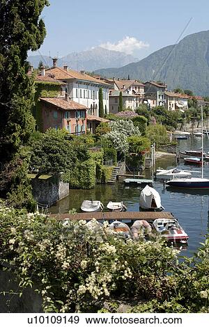 Lago di Como lakeside homes and docks with pleasure boats near Urio Italy View Large Photo Image Stock Photo - Lago di Como lakeside homes and docks with pleasure boats near Urio Italy. Fotosearch