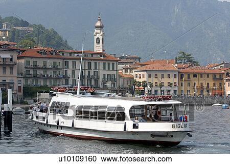 Stock Image - Lago di Como passenger ferry docking at Menaggio Italy. Fotosearch