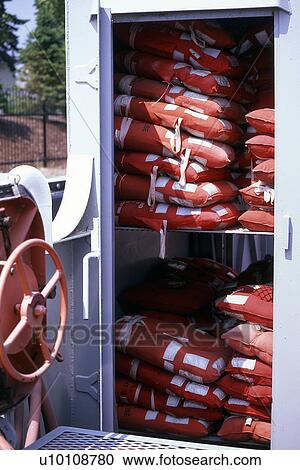 Stock Image - Locker full of Lifejackets on boat. Fotosearch