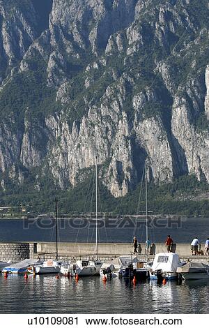 Sailboats in harbour Lago di Como Italy mountain beyond View Large Photo Image Stock Image - Sailboats in harbour Lago di Como Italy mountain beyond. Fotosearch