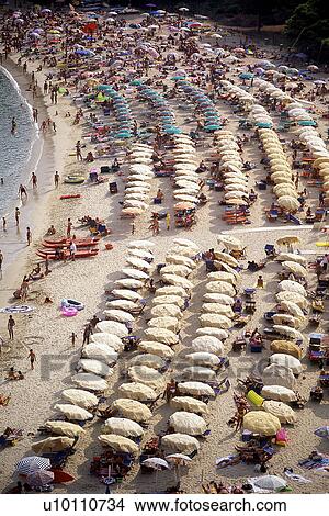 Beach with rows of umbrellas and bathers Elba Italy View Large Photo Image Picture - Beach with rows of umbrellas and bathers Elba Italy. Fotosearch