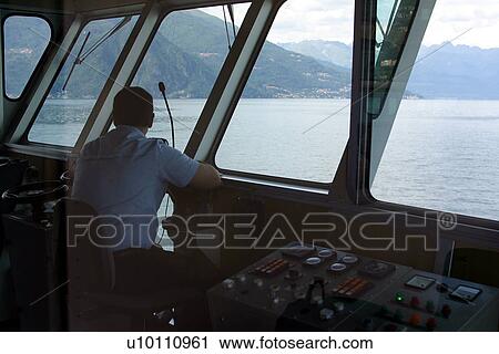 Stock Image - Captain on ferry bridge. Fotosearch