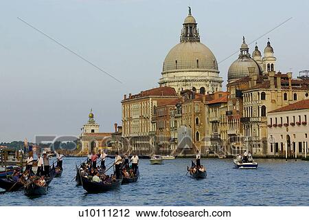 Church Santa Maria delle Salute at edge of Grande Canal. Gondola and boats in canal. Dogana building with gold orb in background. View Large Photo Image Stock Image - Church Santa Maria delle Salute at edge of Grande Canal. Gondola and boats in canal. Dogana building with gold orb in background.. Fotosearch