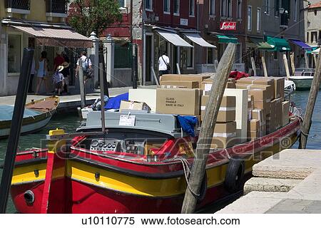 DHL barge at canal side in Murano, loaded with cardboard boxes of glassware View Large Photo Image Stock Photography - DHL barge at canal side in Murano, loaded with cardboard boxes of glassware. Fotosearch