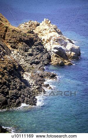 Rocky shoreline and blue green water of coastline Elba Italy View Large Photo Image Stock Photo - Rocky shoreline and blue green water of coastline Elba Italy. Fotosearch