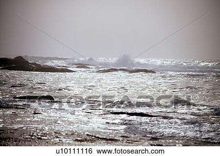 Stock Photograph - Shoreline vistas with waves and mist Devon near Newquay England UK. Fotosearch