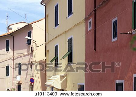 Brightly painted pink, cream and red brown houses View Large Photo Image Stock Photo - Brightly painted pink, cream and red brown houses. Fotosearch