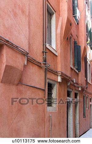 Stock Photography - Typical pink building facade of 'modern' apartment. Fotosearch