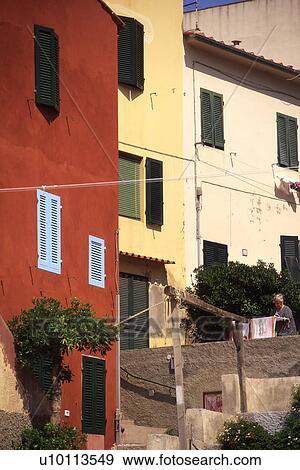 Stock Photo - Brightly painted houses in Elba, Italy. Fotosearch