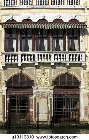 Stock Image - Palazzo front with gated water entrance. Fotosearch