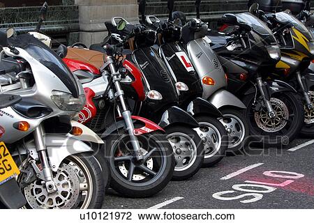 Motor bikes parked on London street View Large Photo Image Stock Image - Motor bikes parked on London street. Fotosearch