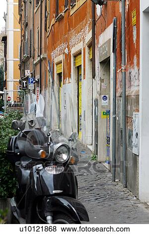 Motor bikes parked on Rome street View Large Photo Image Stock Photo - Motor bikes parked on Rome street. Fotosearch