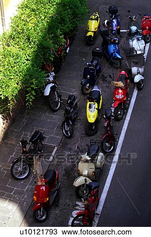 Motor bikes parked on Siena street, viewed from above View Large Photo Image Stock Image - Motor bikes parked on Siena street, viewed from above. Fotosearch