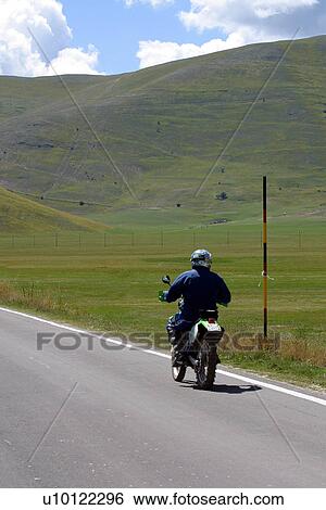 single motor bike on road, Piano Grande, Umbria, Italy View Large Photo Image Stock Photograph - single motor bike on road, Piano Grande, Umbria, Italy. Fotosearch