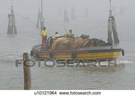 Picture - Yellow barge, with tank in morning fog, Venezia lagoon. Fotosearch
