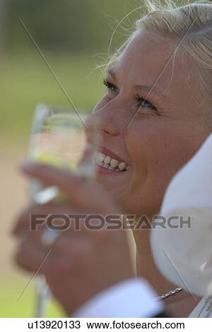 Stock Image - toast, champagne, drink, close-up, woman. Fotosearch