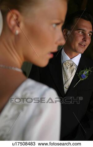 Stock Image - woman, couple, standing, gown, formal. Fotosearch