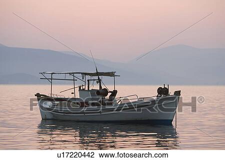 Stock Image - Dusk, Leisure Activity, Recreational Pursuit, Fishing, Anchored. Fotosearch