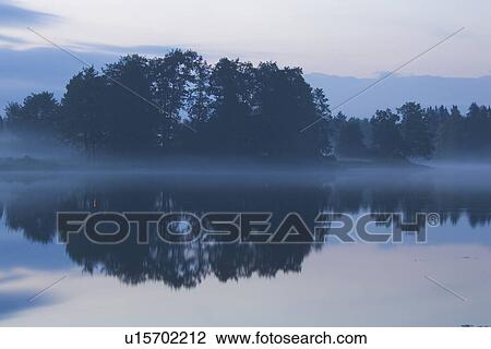 Stock Image - Dusk, Fog, Haze, Lake. Fotosearch