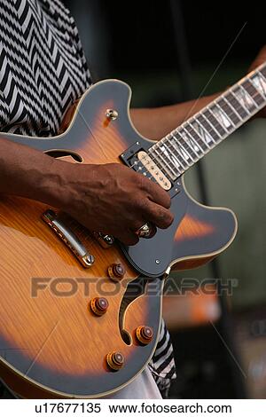 Stock Photography - guitar, guitarist, close-up, fingers, strumming, playing. Fotosearch