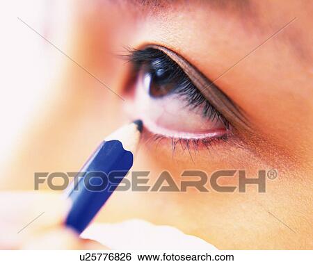 A Woman Applying Blue-colored Eyeliner, Differential Focus View Large Photo Image Stock Photograph - A Woman Applying Blue-colored Eyeliner, Differential Focus. Fotosearch