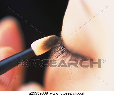 A Woman Applying Brown-colored Eye Shadow, Differential Focus View Large Photo Image Stock Photo - A Woman Applying Brown-colored Eye Shadow, Differential Focus. Fotosearch