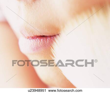 Stock Image - A Woman Applying Face Powder with a Brush, Differential Focus. Fotosearch