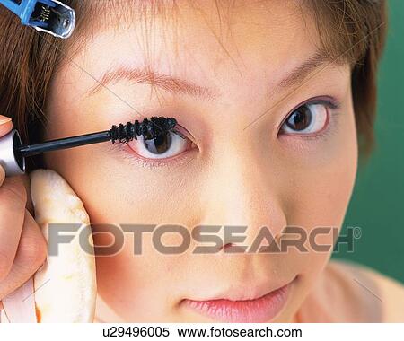 A Woman Applying Mascara, Front View, Looking at Camera, Differential Focus View Large Photo Image Stock Photography - A Woman Applying Mascara, Front View, Looking at Camera, Differential Focus. Fotosearch