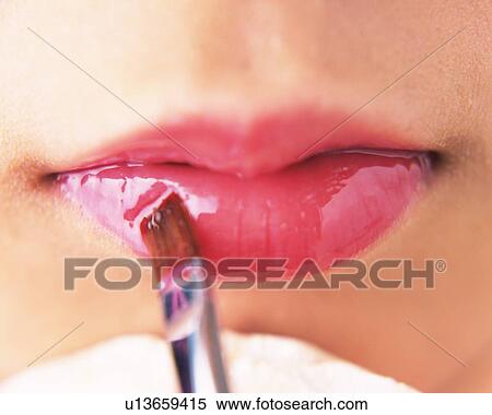 A Woman Applying Pink-Colored Lip Gloss, Front View, Differential Focus View Large Photo Image Stock Photography - A Woman Applying Pink-Colored Lip Gloss, Front View, Differential Focus. Fotosearch