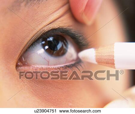 A Woman Applying White-Colored Eye Liner, Differential Focus View Large Photo Image Stock Image - A Woman Applying White-Colored Eye Liner, Differential Focus. Fotosearch