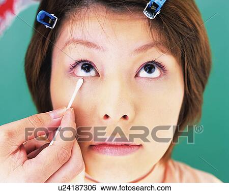 A Woman Swabbing the Skin Around Eye, Front View, Looking Up, Differential Focus View Large Photo Image Stock Photograph - A Woman Swabbing the Skin Around Eye, Front View, Looking Up, Differential Focus. Fotosearch