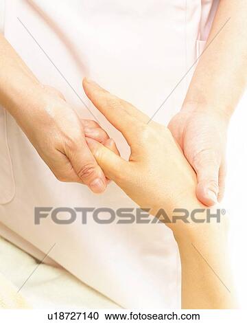 Stock Image - Aesthetician Who Massages Back of Woman's Hand, Close Up. Fotosearch