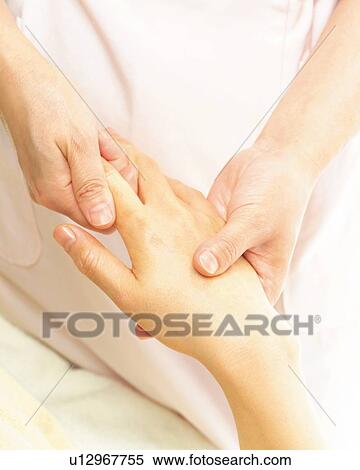 Stock Photography - Aesthetician Who Massages Back of Woman's Hand, Close Up. Fotosearch