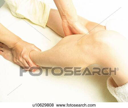Stock Photo - Aesthetician Who Massages Woman's Foot, High Angle View. Fotosearch