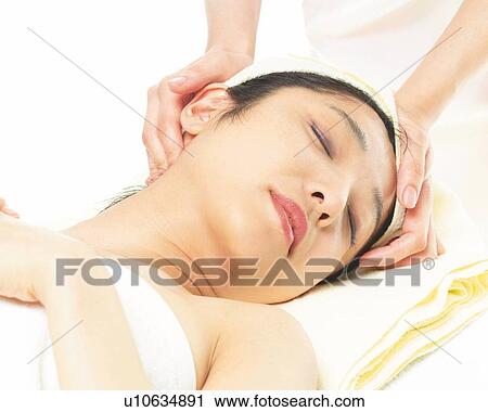 Stock Image - Aesthetician Who Massages Woman's Head, High Angle View. Fotosearch