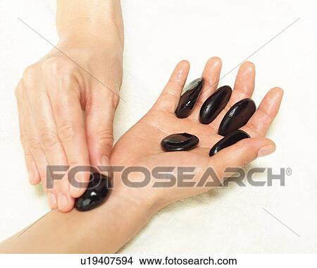 Aesthetician Who Pushes Woman's Hand With Stones, High Angle View, Close Up View Large Photo Image Picture - Aesthetician Who Pushes Woman's Hand With Stones, High Angle View, Close Up. Fotosearch