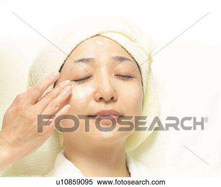 Aesthetician Who Rubs Cream on Woman's Face, High Angle View View Large Photo Image Stock Photography - Aesthetician Who Rubs Cream on Woman's Face, High Angle View. Fotosearch