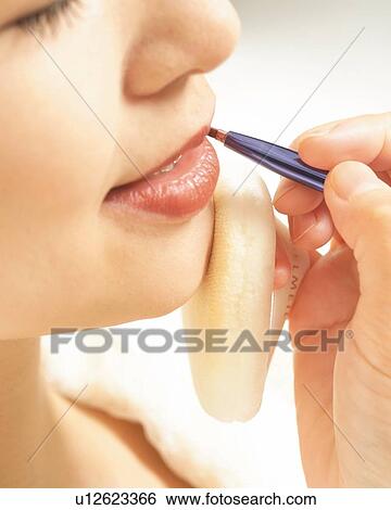 Stock Photograph - Aesthetician Who Wears Red Lipstick, Side View. Fotosearch