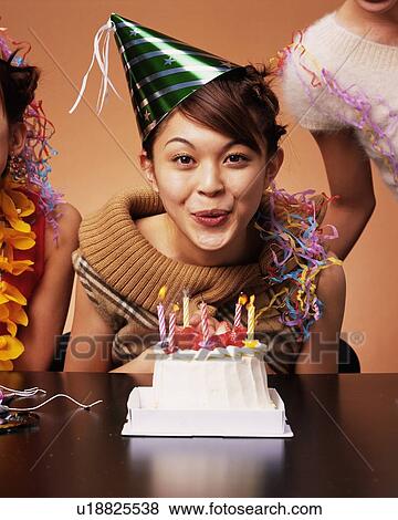 A Young Woman Celebrating Her Birthday Party with Some Friends, Front View, Looking at Camera  View Large Photo Image Stock Photo - A Young Woman Celebrating Her Birthday Party with Some Friends, Front View, Looking at Camera . Fotosearch