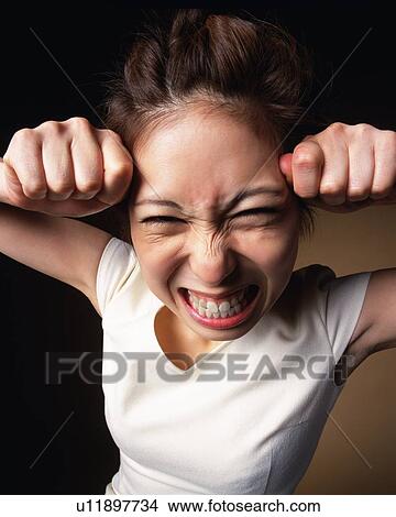 Angry Young Woman, High Angle View, Looking at Camera View Large Photo Image Picture - Angry Young Woman, High Angle View, Looking at Camera. Fotosearch
