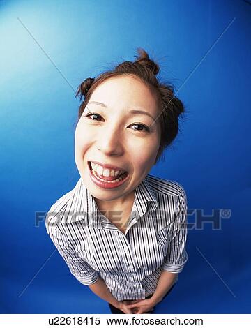 Stock Photography - Smiling Young Woman, High Angle View, Fish-Eye. Fotosearch