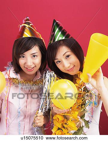 Two Young Women Having a Party, High Angle View, Looking at Camera View Large Photo Image Stock Image - Two Young Women Having a Party, High Angle View, Looking at Camera. Fotosearch