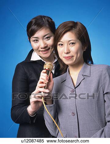 Two Young Women Singing Karaoke, Front View, Looking at Camera View Large Photo Image Stock Photography - Two Young Women Singing Karaoke, Front View, Looking at Camera. Fotosearch