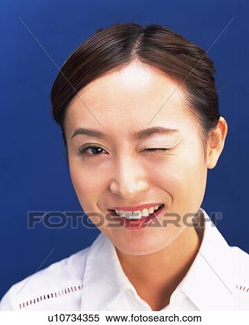 Winking Young Woman, Front View, Looking at Camera View Large Photo Image Stock Photography - Winking Young Woman, Front View, Looking at Camera. Fotosearch