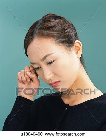 Stock Image - Young Woman Having a Headache, Side View. Fotosearch