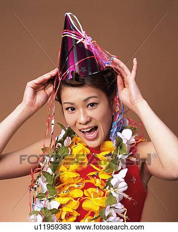 Stock Image - Young Woman Having a Party, Front View, Looking at Camera. Fotosearch